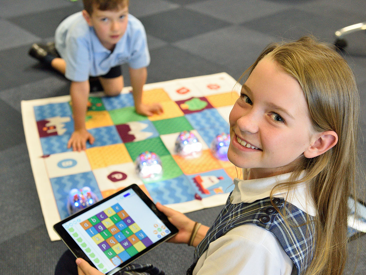 young girl smiling playing tablet in new housing estate sunshine coast