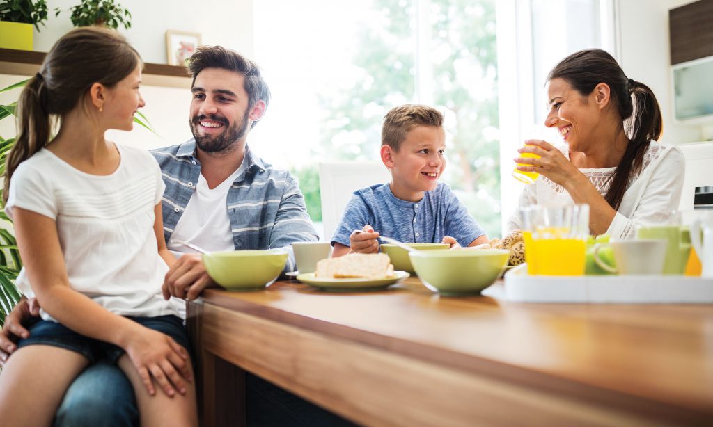 family smiling having breakfast before they buy house and land sunshine coast